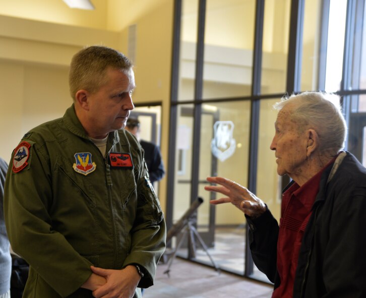 Col. James Cluff, 432nd Wing/432nd Air Expeditionary Wing commander, and retired U.S. Air Force colonel Linus Upson Jr. chat during a base tour Nov. 27, 2013. Upson, who was previously the base commander in 1945, saw the improvements within the remotely piloted community and learned about the RPA mission. He also shared his experiences and what the mission was like during his time as the commander at the end of World War II. (U.S. Air Force photo by Senior Airman A.K.)