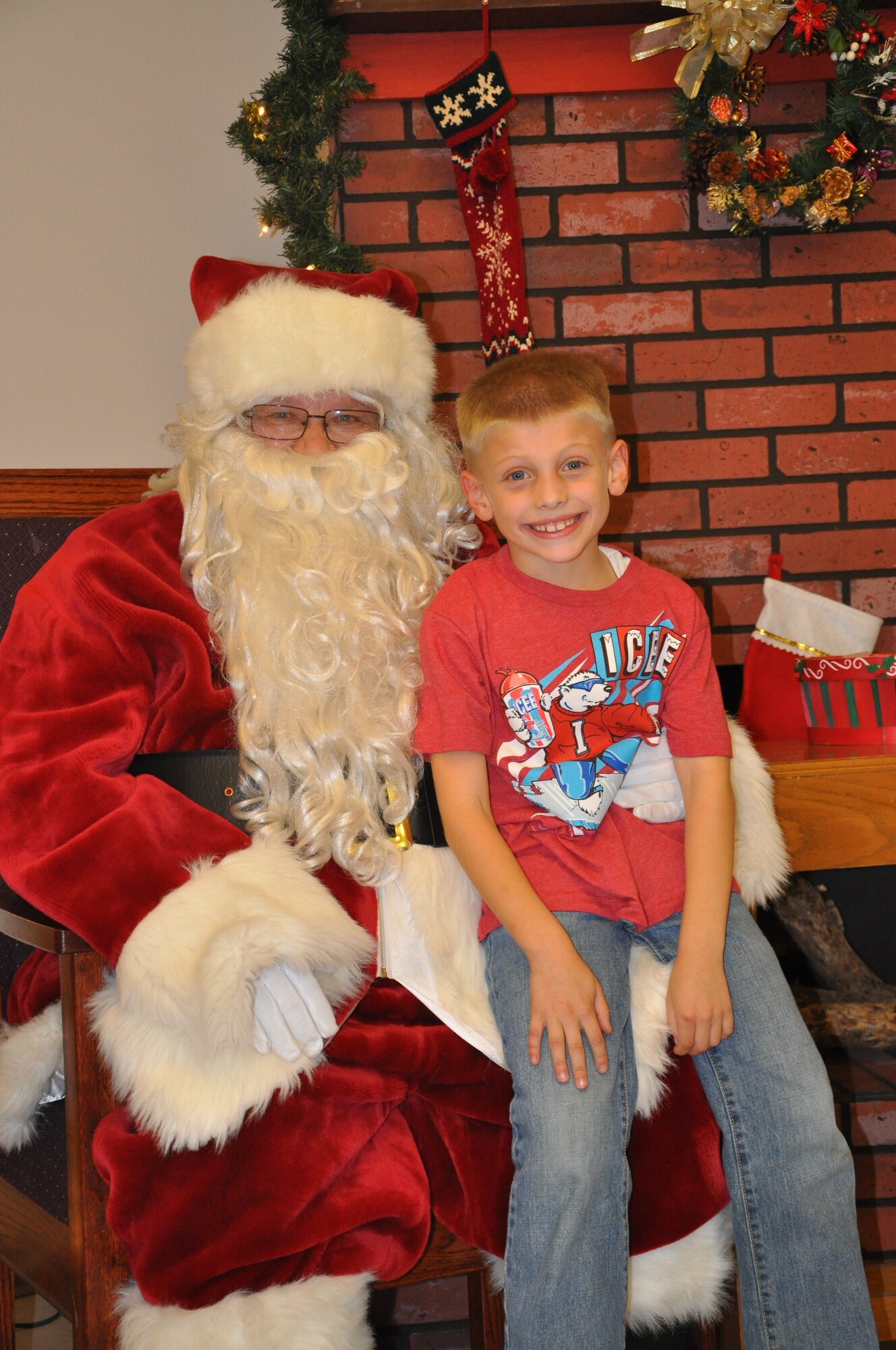 GOODFELLOW AIR FORCE BASE, Texas – A military child sits on Santa’s lap during the Holiday Tree Lighting at the base chapel Dec. 3. Along with sitting with Santa, children also had cookies and hot chocolate to drink. (U.S. Air Force photo/ Airman 1st Class Breonna Veal)