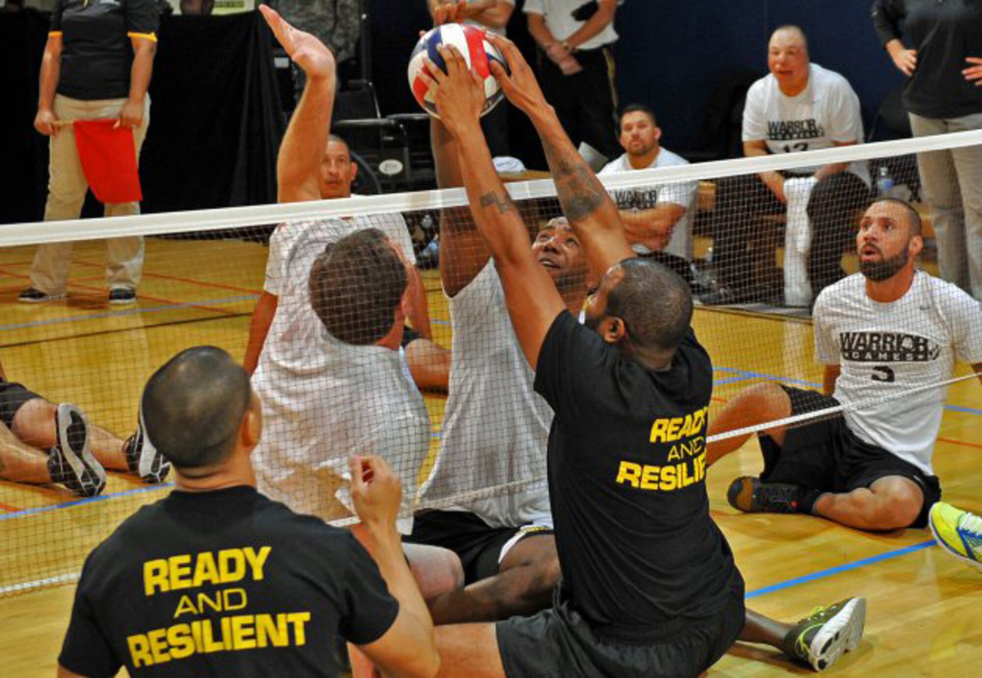 An Army wounded warrior attempts to score against the U.S. Special Operations Command team at the 3rd Annual Joint Services Sitting Volleyball Tournament held at the Pentagon, Nov. 21, 2013. The volleyball tournament was held in conjunction with Warrior Care Month. (Courtesy photo/U.S. Army)

 
