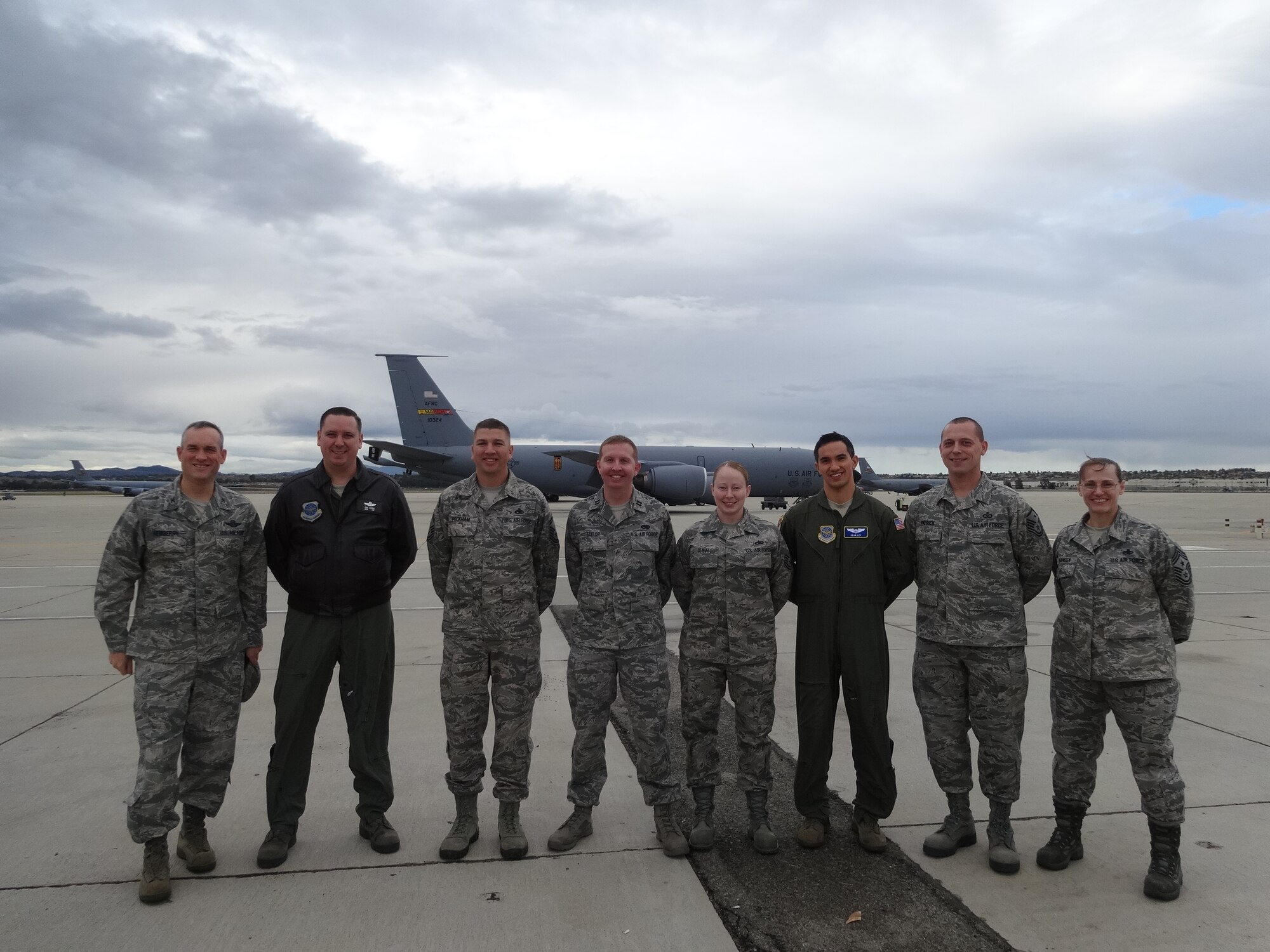 Col. Brian Newberry, the 92nd Air Refueling Wing commander, and Chief Master Sgt. Wendy Hansen, the 92nd ARW command chief, pose with 912th Air Refueling Squadron Airmen during their visit at March Air Reserve Base, Calif., Nov. 22, 2013. The colonel is the administrative commander for 912th ARS Airmen and said during his visit that they have demonstrated incredible imagination, flexibility and vision as critical members of his Total Force team. (U.S. Air Force courtesy photo/Released)