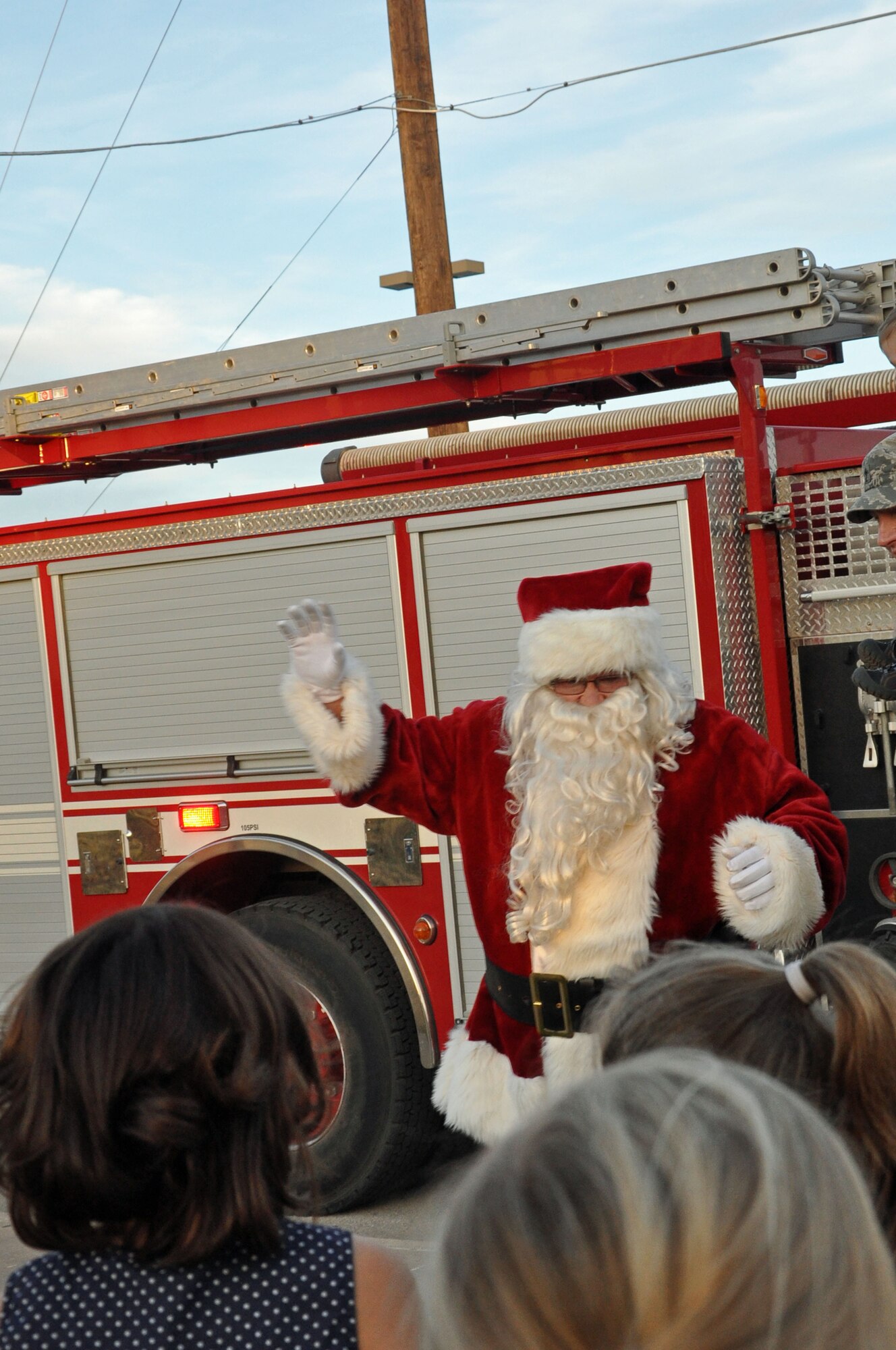 GOODFELLOW AIR FORCE BASE, Texas – Santa Claus greets children after arriving on a fire truck during the Holiday Tree Lighting Ceremony at the base chapel Dec. 3. Children had the opportunity to sit on Santa’s lap and tell him what they want for Christmas. (U.S. Air Force photo/ Airman 1st Class Breonna Veal)