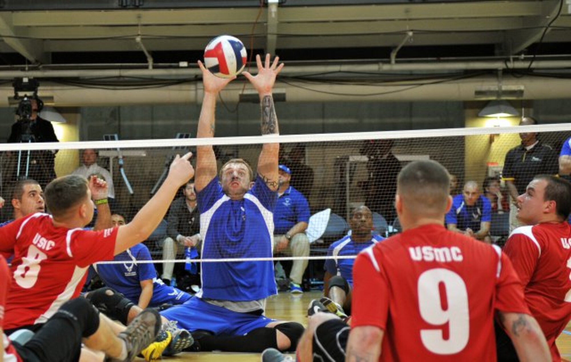 An Air Force wounded warrior goes for the stuff against the Marine Corps wounded warriors at the 3rd Annual Joint Sitting Volleyball Tournament, Nov. 21, 2013, at the Pentagon. The Marine Corps beat Air Force in the best of three games and took home the 1st-place trophy. (U.S. Air Force photo/J.D. Leipold)

