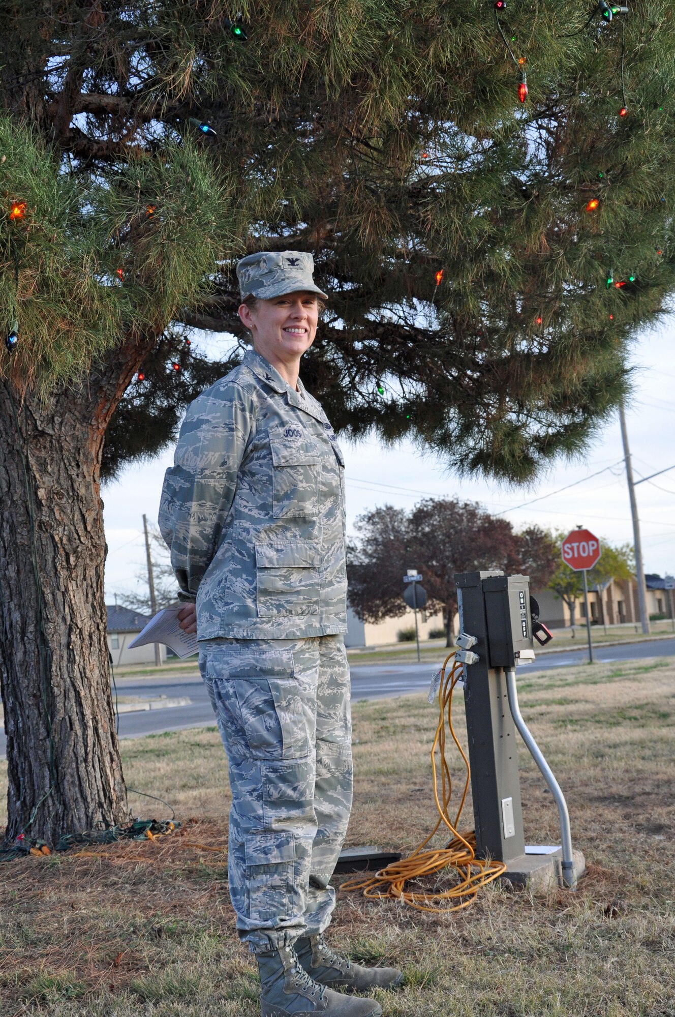 GOODFELLOW AIR FORCE BASE, Texas -- Col. Kimberlee Joos, 17th Training Wing Commander, poses for a picture in front of the tree during the Holiday Tree Lighting Ceremony at the base chapel Dec. 3. Col. The tree lighting ceremony is a tradition held at Air Force bases every year, marking the beginning of the winter holiday season. (U.S. Air Force photo/ Airman 1st Class Breonna Veal)