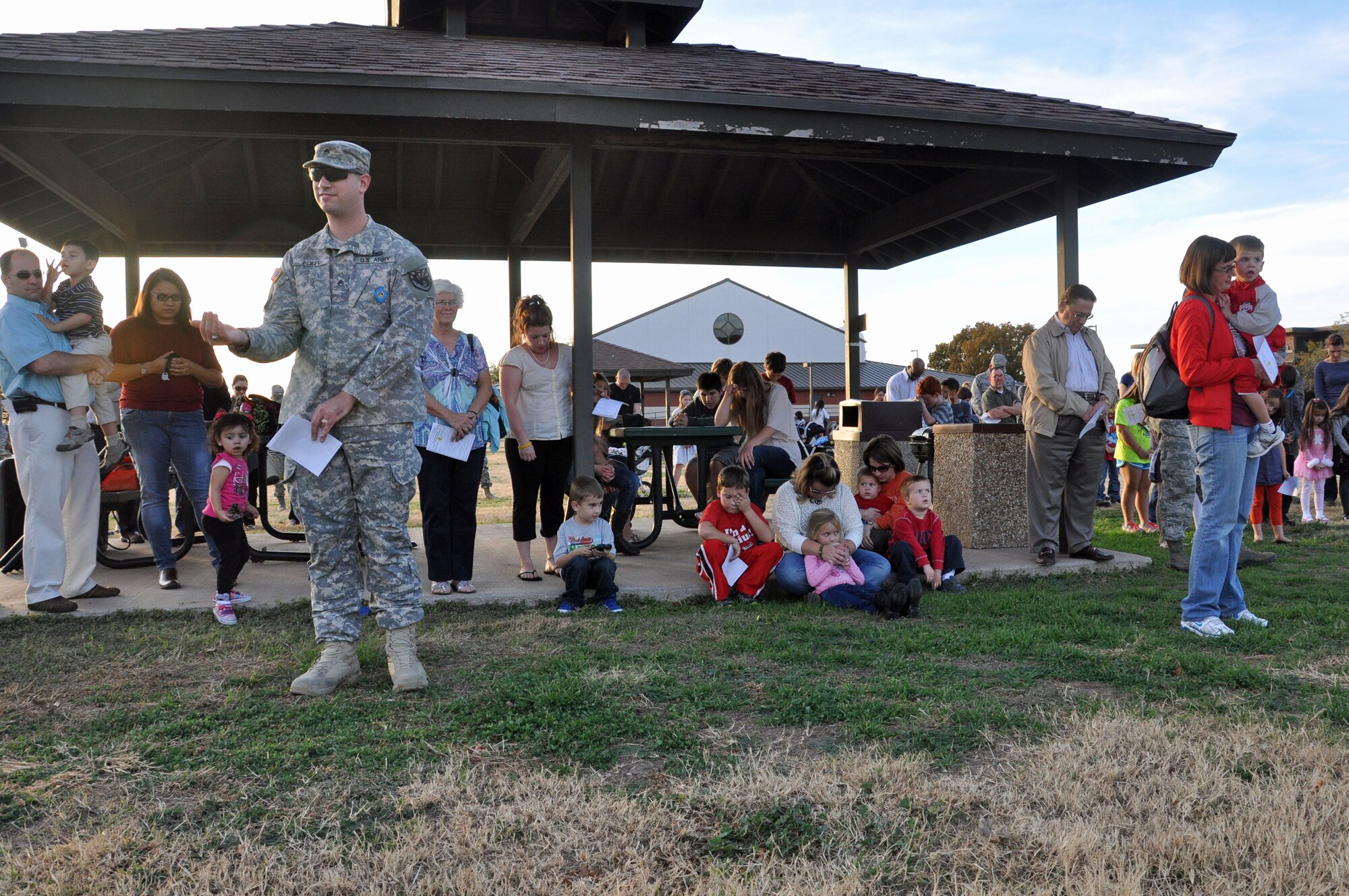GOODFELLOW AIR FORCE BASE, Texas – Service members and their families stand outside the base chapel waiting for the lighting of the holiday tree during the Holiday Tree Lighting Ceremony Dec. 3. The event included caroling, a photo opportunity with Santa, hot chocolate and cookies.  (U.S. Air Force photo/ Airman 1st Class Breonna Veal)