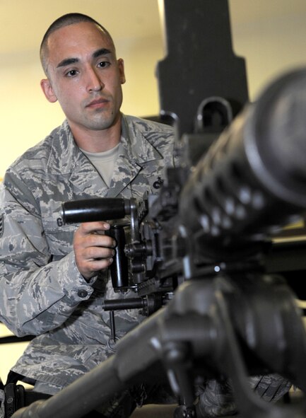 Staff Sgt. Nicholas Gallo, a combat arms instructor with the 71st Security Forces Squadron at Vance Air Force Base, Okla., performs maintenance on a .50-caliber machine gun. He is a winner of the “First Faces” award, given by the Air Education and Training Command Chaplain Corps to Airmen who make important contributions to AETC. (U.S. Air Force photo/ Senior Airman Frank Casciotta)