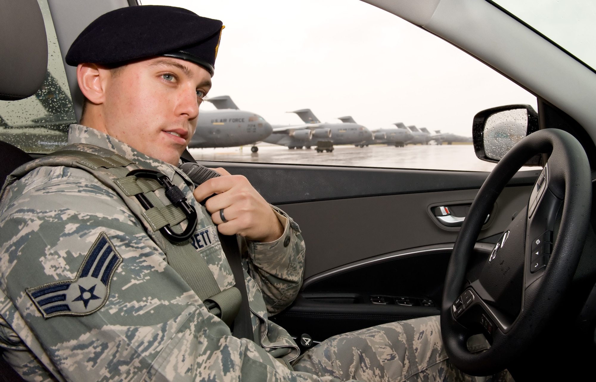 Senior Airman Justin Jarrett, 436th Security Forces Squadron response force leader, makes a radio call to the base defense operations center while patrolling the flight line Nov. 27, 2013, at Dover Air Force Base, Del. Jarrett was named Air Mobility Command's winner of the 2013 Outstanding Security Forces Flight-Level Airman Award. (U.S. Air Force photo/Roland Balik)
