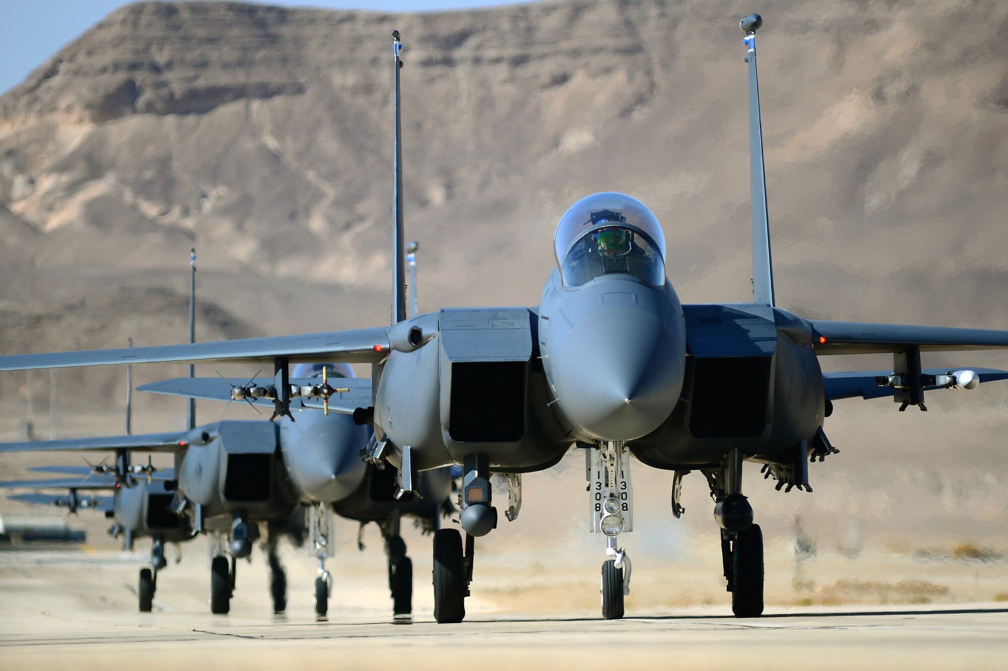 A group of F-15E Strike Eagles taxi, following a combat mission during Blue Flag exercise on Uvda Air Force Base, Israel, Nov. 26, 2013. Aircraft from the 492nd Fighter Squadron, Royal Air Force Lakenheath, England, deployed to participate in the exercise, where they engaged multiple heavy air defense assets, ground base targets and simulated opposition forces to meet combined operations requirements. (U.S. Air Force photo by Master Sgt. Lee Osberry/Released)