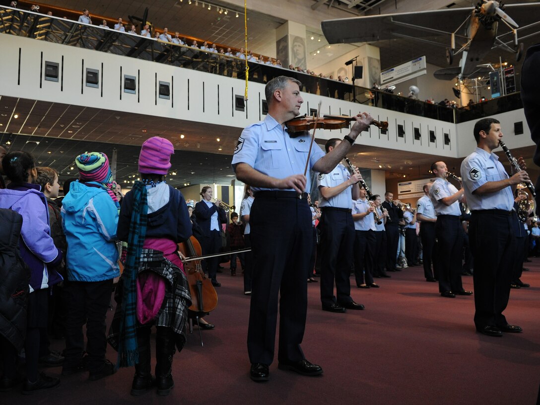 The United States Air Force Band performs a flash mob at the Smithsonian's National Air and Space Museum Washington, D.C., Dec. 3, 2013. The band conducted the flash mob to promote their upcoming holiday concerts at the Air and Space Museum Dec. 5th, 6th, and 7th. The concerts are free of charge and open to all. (U.S. Air Force photo by/ Airman 1st Class Nesha Humes)