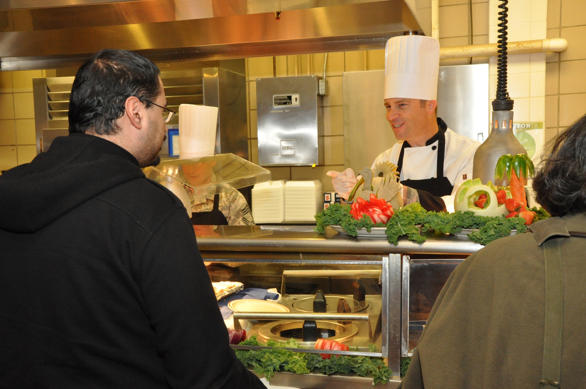 GOODFELLOW AIR FORCE BASE, Texas – Col. Thomas Schmidt, 17th Training Wing Vice Commander, takes Western Winds Dining Facility patron Omar Fuentes’ order during Thanksgiving at the Western Winds Dining Facility Nov. 28. Col. Schmidt served Fuentes and hundreds of other customers a meal in celebration of the Thanksgiving holiday. (U.S. Air Force photo/ Senior Airman Joshua Edwards)
