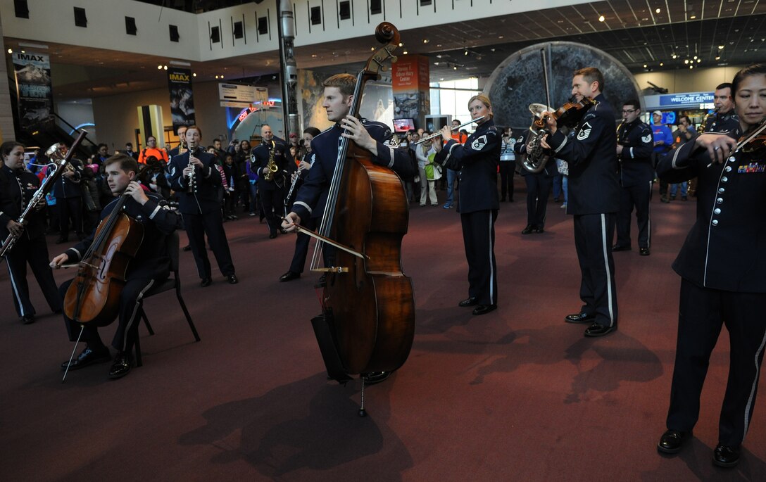 The United States Air Force Band performs during a flash mob at the Smithsonian's National Air and Space Museum Washington, D.C., Dec. 3, 2013. The band conducted the flash mob to promote their upcoming holiday concerts in the National Capitol Region. (U.S. Air Force photo by/ Airman 1st Class Nesha Humes)