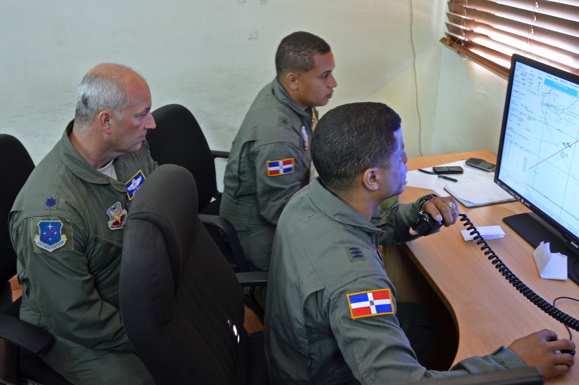 Lt. Col. Jeff Doyle, a U.S. Air Force air battle manager, observes as two Dominican Republic air force weapons control officers direct Dominican Republic A-29 Super Tucanos to intercept a simulated drug-trafficking ship as part of an exercise to combat illegal drug trafficking Dec. 3, 2013, over the skies of the Caribbean. The exercise is part of the Sovereign Skies Program, an initiative between the U.S., Colombian, and Dominican Republic air forces to share best-practices on procedures to detect, track and intercept illegal drugs moving north from South America. (U.S. Air Force photo by Capt. Justin Brockhoff/Released)







