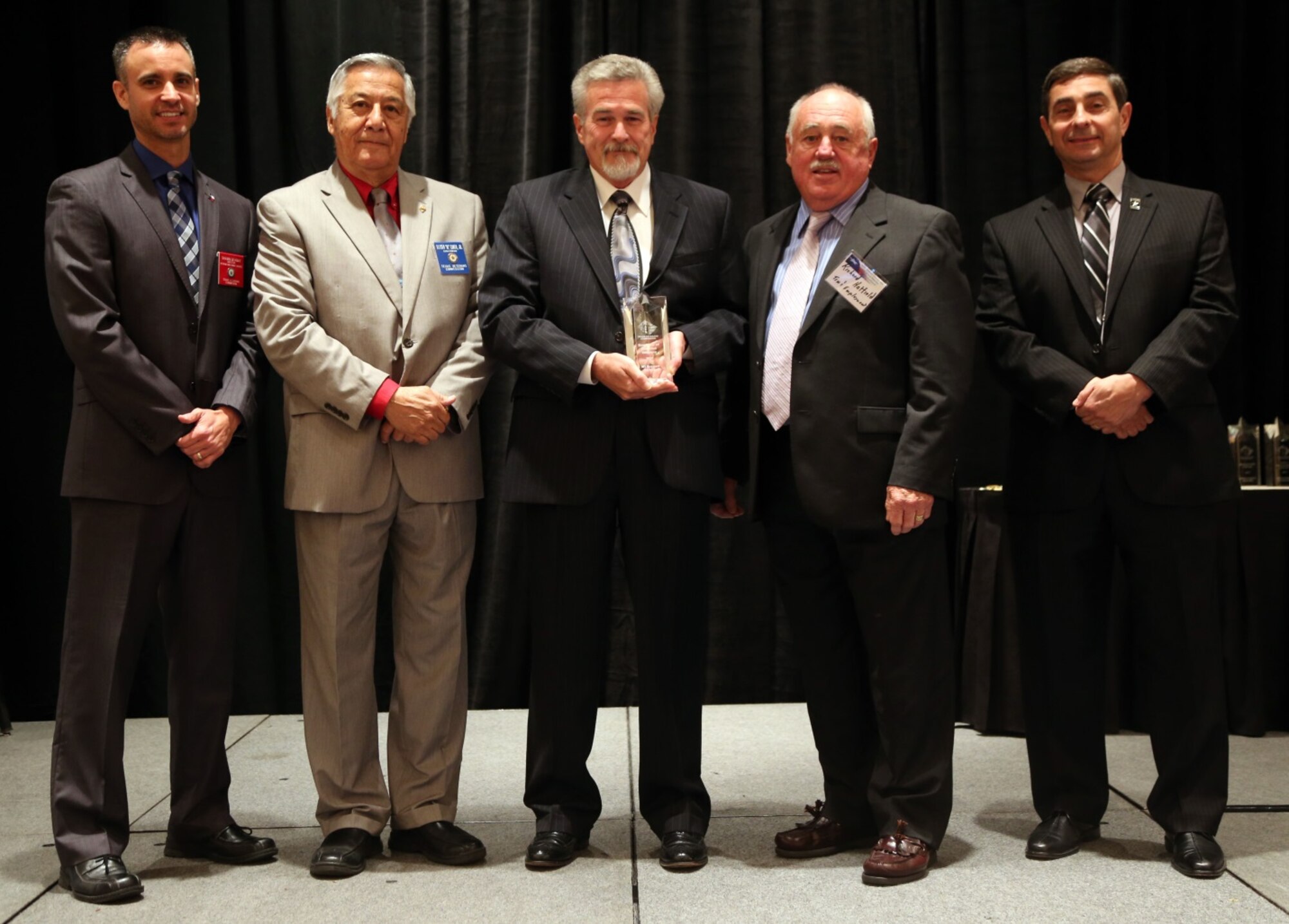 Gene Killion, center, M1 Support Services Corporate Office, receives the Disabled Veteran Employer award on behalf of M1 Support Services Sept. 22, 2013 in Dallas. M1 Support Services is a service-disabled, veteran-owned small business with a wide range of capabilities in aviation support services, logistics, information technology, training services, supply chain management, acquisition and facilities and equipment maintenance. They provide responsive, high quality technical solutions to a wide range of federal government customers. (Courtesy photo)
