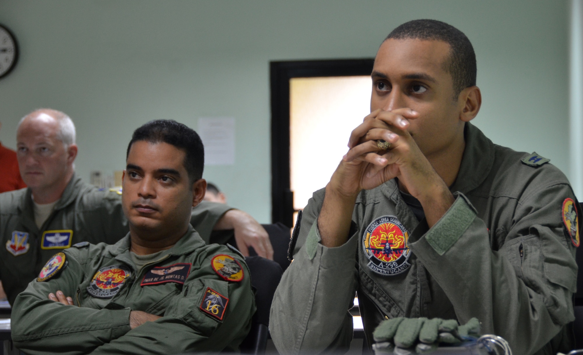 Dominican Republic air force A-29 Super Tucano pilots listen to a briefing on air-to-air intercept tactics with U.S. Air Force counterparts as part of an exercise to combat illegal drug trafficking Dec. 3, 2013, over the skies of the Caribbean. The exercise is part of the Sovereign Skies Expansion Program, an initiative between the U.S., Colombian, and Dominican Republic air forces to share best-practices on procedures to detect, track and intercept illegal drugs moving north from South America. (U.S. Air Force photo by Capt. Justin Brockhoff/Released)












