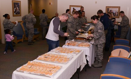 Parents and their children gather for a Thanksgiving lunch held by the Child Development Center Nov. 21, 2013, at Joint Base Charleston – Air Base, S.C. The CDC has held this event for more than 16 years. The children and their parents enjoyed turkey, dressing, candy yams, green beans, rolls and apple and potato pie. (U.S. Air Force photo/ Airman 1st Class Chacarra Neal)