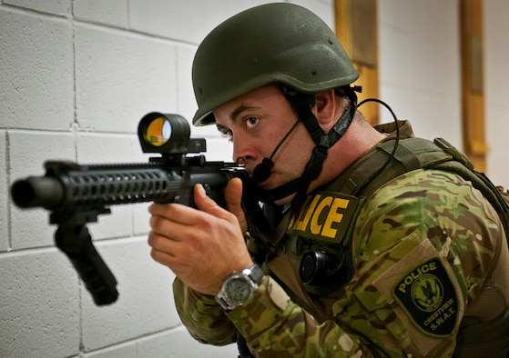 A member of the Crestview Police Department SWAT guards a door as their team members clear a room at the Naval School Explosive Ordnance Disposal building during an active shooter exercise on Eglin Air Force Base, Fla., Dec. 3. Police and first responders from Eglin and the surrounding communities participated in the joint exercise in which a person with two weapons entered the building and began shooting students.  The SWAT team made sure the building was safe to enter.  Then firefighters moved the victims out to the triage area where local emergency medical technicians provided care.  (U.S. Air Force photo/Samuel King Jr.)