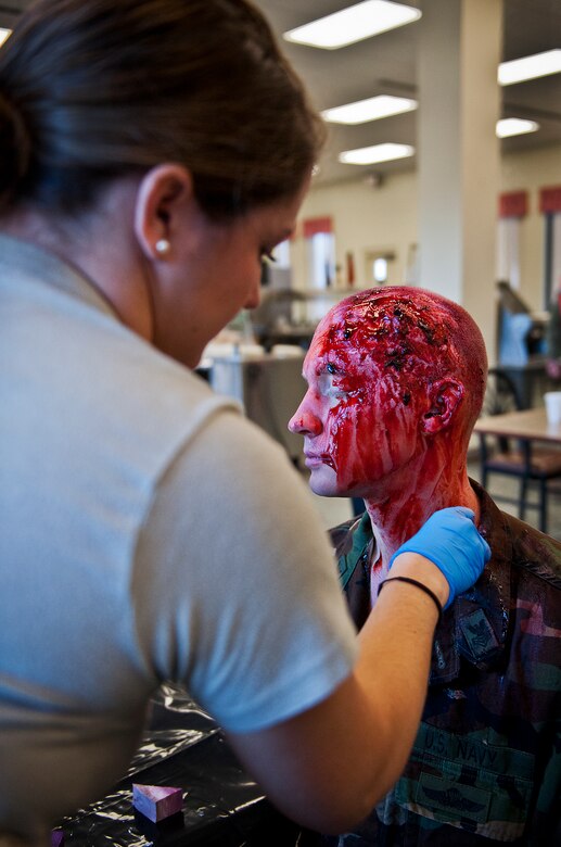 A simulated victim gets “gored” up by the 96th Medical Group’s moulage team prior to an active shooter exercise at the Naval School Explosive Ordnance Disposal building Dec. 3. Police and first responders from Eglin and the surrounding communities participated in the joint exercise in which a person with two weapons entered the building and began shooting students.  The SWAT team made sure the building was safe to enter.  Then firefighters moved the victims out to the triage area where local emergency medical technicians provided care.  (U.S. Air Force photo/Samuel King Jr.)