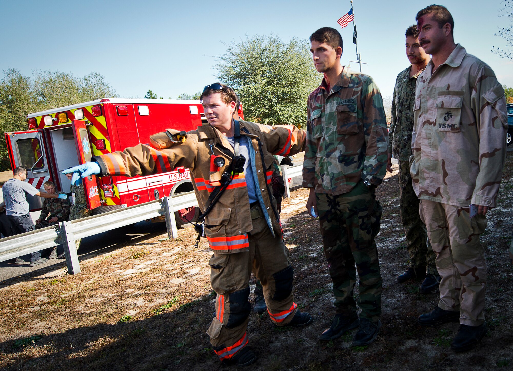 An Eglin Air Force Base firefighter directs the wounded toward the triage area during an active shooter exercise at the Naval School Explosive Ordnance Disposal building Dec. 3. Police and first responders from Eglin and the surrounding communities participated in the joint exercise in which a person with two weapons entered the building and began shooting students.  The SWAT team made sure the building was safe to enter.  Then firefighters moved the victims out to the triage area where local emergency medical technicians provided care.  (U.S. Air Force photo/Samuel King Jr.)