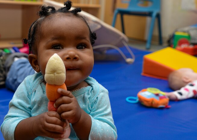 Leilani Jones, 8-month old daughter  of Technical Sgt. Rikkitea Jones, 628th Medical Support Squadron non-commissioned officer in charge of pharmacy support, holds a stuffed animal during a Thanksgiving lunch held by the Child Development Center Nov. 21, 2013, at Joint Base Charleston – Air Base, S.C. The CDC has held this event for more than 16 years. The children and their parents enjoyed turkey, dressing, candy yams, green beans, rolls and apple and potato pie. (U.S. Air Force photo/ Airman 1st Class Chacarra Neal)