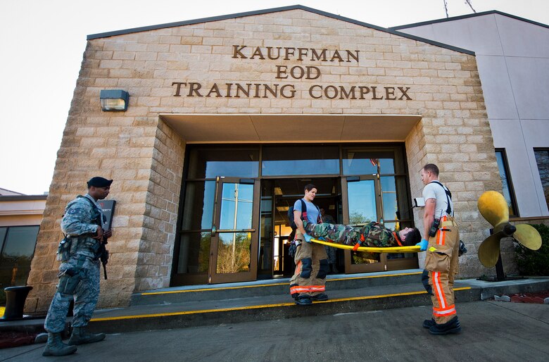 Amber Turek and Airman 1st Class Ryan Falk, 96th Test Wing firefighters, carry out a simulated victim from the Naval School Explosive Ordnance Disposal building during an active shooter exercise on Eglin Air Force Base, Fla., Dec. 3. Police and first responders from Eglin and the surrounding communities participated in the joint exercise in which a person with two weapons entered the building and began shooting students.  The SWAT team made sure the building was safe to enter.  Then firefighters moved the victims out to the triage area where local emergency medical technicians provided care.  (U.S. Air Force photo/Samuel King Jr.)