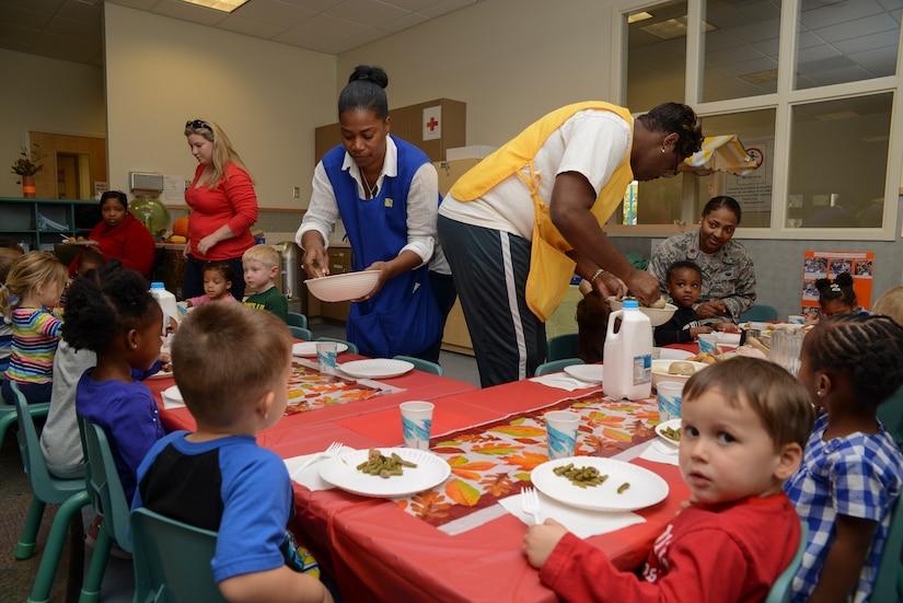 Teachers pass out food to children during the Thanksgiving lunch held at the Child Development Center Nov. 21, 2013, at Joint Base Charleston – Air Base, S.C. The CDC has held this event for more than 16 years. The children and their parents enjoyed turkey, dressing, candy yams, green beans, rolls and apple and potato pie. (U.S. Air Force photo/ Airman 1st Class Chacarra Neal)