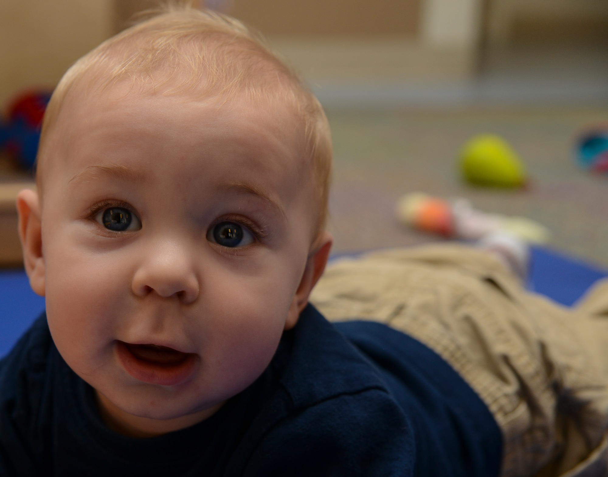 Avery Wood, 7-month old son of Technical Sgt. Kathryn Wood, 628th Force Support Squadron readiness non-commissioned officer, smiles while playing during a Thanksgiving lunch held by the Child Development Center Nov. 21, 2013, at Joint Base Charleston – Air Base, S.C. The CDC has held this event for more than 16 years. The children and their parents enjoyed turkey, dressing, candy yams, green beans, rolls and apple and potato pie. (U.S. Air Force photo/ Airman 1st Class Chacarra Neal)