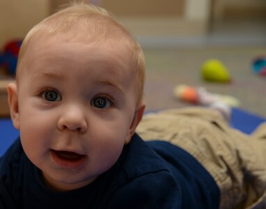 Avery Wood, 7-month old son of Technical Sgt. Kathryn Wood, 628th Force Support Squadron readiness non-commissioned officer, smiles while playing during a Thanksgiving lunch held by the Child Development Center Nov. 21, 2013, at Joint Base Charleston – Air Base, S.C. The CDC has held this event for more than 16 years. The children and their parents enjoyed turkey, dressing, candy yams, green beans, rolls and apple and potato pie. (U.S. Air Force photo/ Airman 1st Class Chacarra Neal)