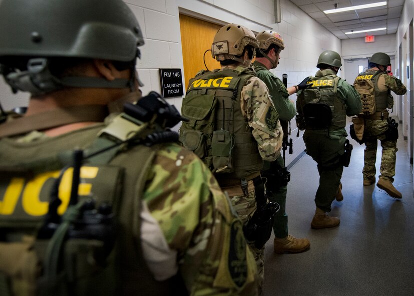 Members of the Crestview Police Department SWAT team clear the rooms of the Naval School Explosive Ordnance Disposal building during an active shooter exercise on Eglin Air Force Base, Fla., Dec. 3. Police and first responders from Eglin and the surrounding communities participated in the joint exercise in which a person with two weapons entered the building and began shooting students.  The SWAT team made sure the building was safe to enter.  Then firefighters moved the victims out to the triage area where local emergency medical technicians provided care.  (U.S. Air Force photo/Samuel King Jr.)
