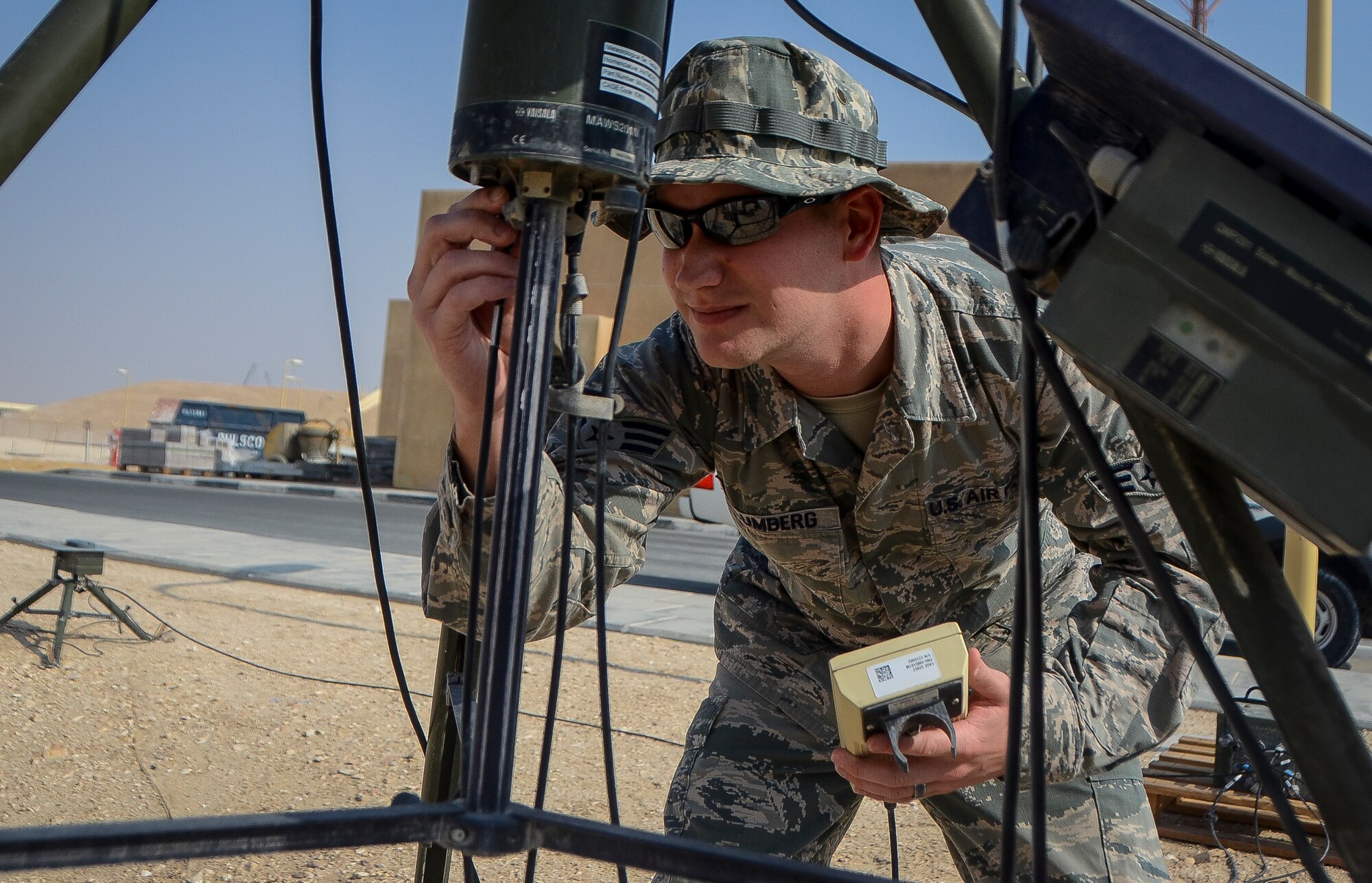 Senior Airman Chase Blumberg inspects the cables of a deployable weather sensor at the 379th Air Expeditionary Wing in Southwest Asia, Dec. 2, 2013. To avoid harsh weather conditions and create the safest route possible, weather forecasts help pilots during takeoff, in flight and when landing. Blumberg, a 379th Expeditionary Operations Support Squadron weather flight forecaster, is part of an eight man shop which monitors weather conditions for flight missions around-the-clock. Blumberg is deployed from Davis-Monthan Air Force Base, Ariz. and hails from Ocala, Fla.  (U.S. Air Force photo/Senior Airman Jared Trimarchi) 