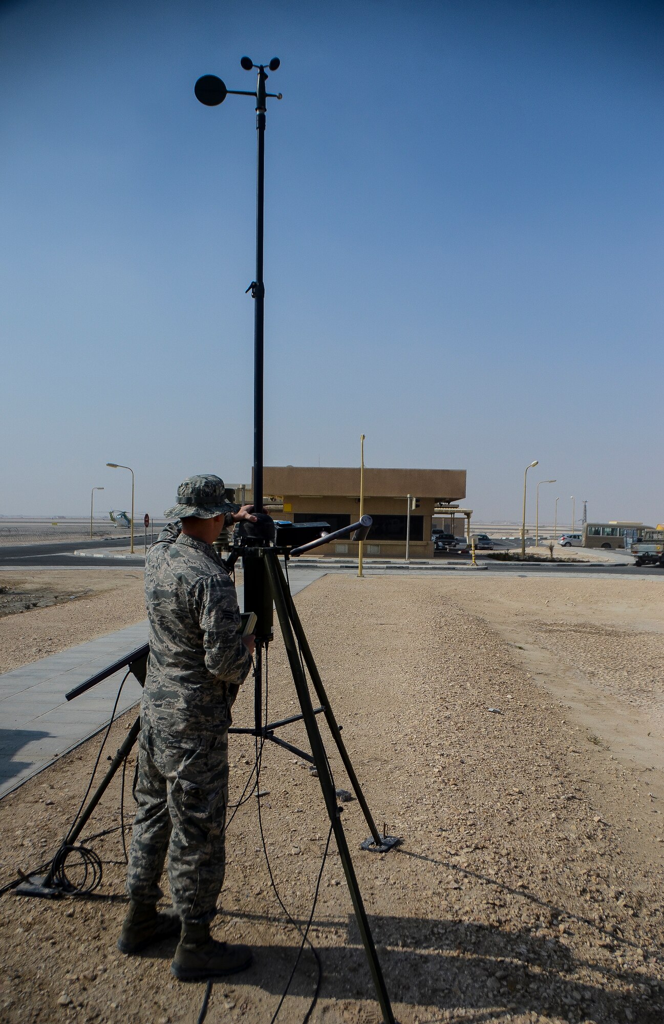 Senior Airman Chase Blumberg inspects a deployable weather sensor at the 379th Air Expeditionary Wing in Southwest Asia, Dec. 2, 2013. To avoid harsh weather conditions and create the safest route possible, weather forecasts help pilots during takeoff, in flight and when landing. Blumberg, a 379th Expeditionary Operations Support Squadron weather flight forecaster, is part of an eight man shop which monitors weather conditions for flight missions around-the-clock. Blumberg is deployed from Davis-Monthan Air Force Base, Ariz. and hails from Ocala, Fla.  (U.S. Air Force photo/Senior Airman Jared Trimarchi) 