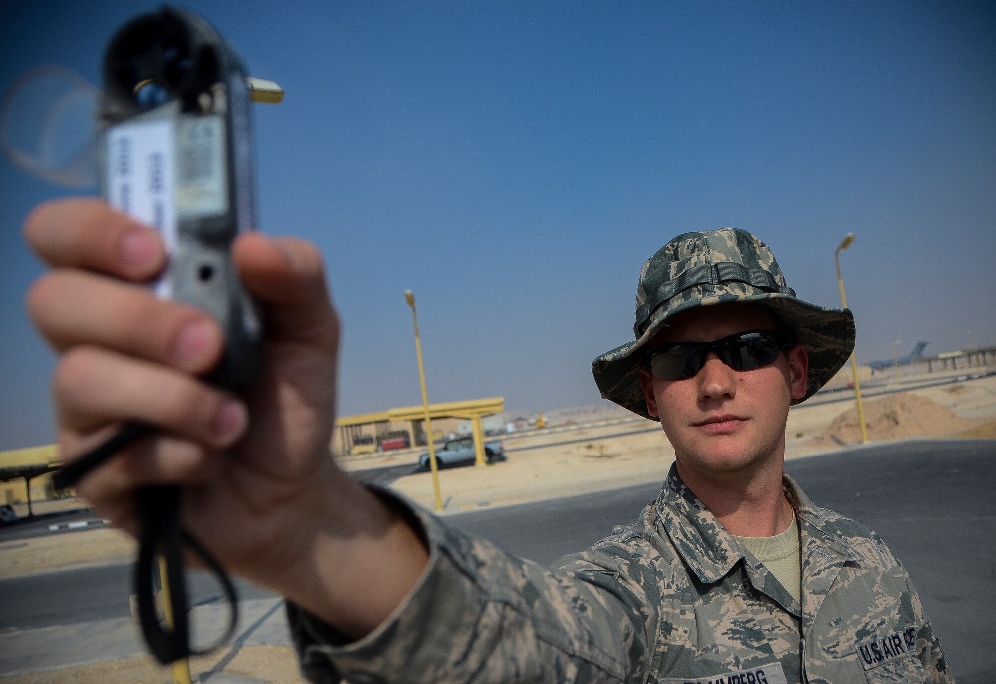 Senior Airman Chase Blumberg reads a handheld weather sensor at the 379th Air Expeditionary Wing in Southwest Asia, Dec. 2, 2013. To avoid harsh weather conditions and create the safest route possible, weather forecasts help pilots during takeoff, in flight and when landing. Blumberg, a 379th Expeditionary Operations Support Squadron weather flight forecaster, is part of an eight man shop which monitors weather conditions for flight missions around-the-clock. Blumberg is deployed from Davis-Monthan Air Force Base, Ariz. and hails from Ocala, Fla. (U.S. Air Force photo/Senior Airman Jared Trimarchi) 