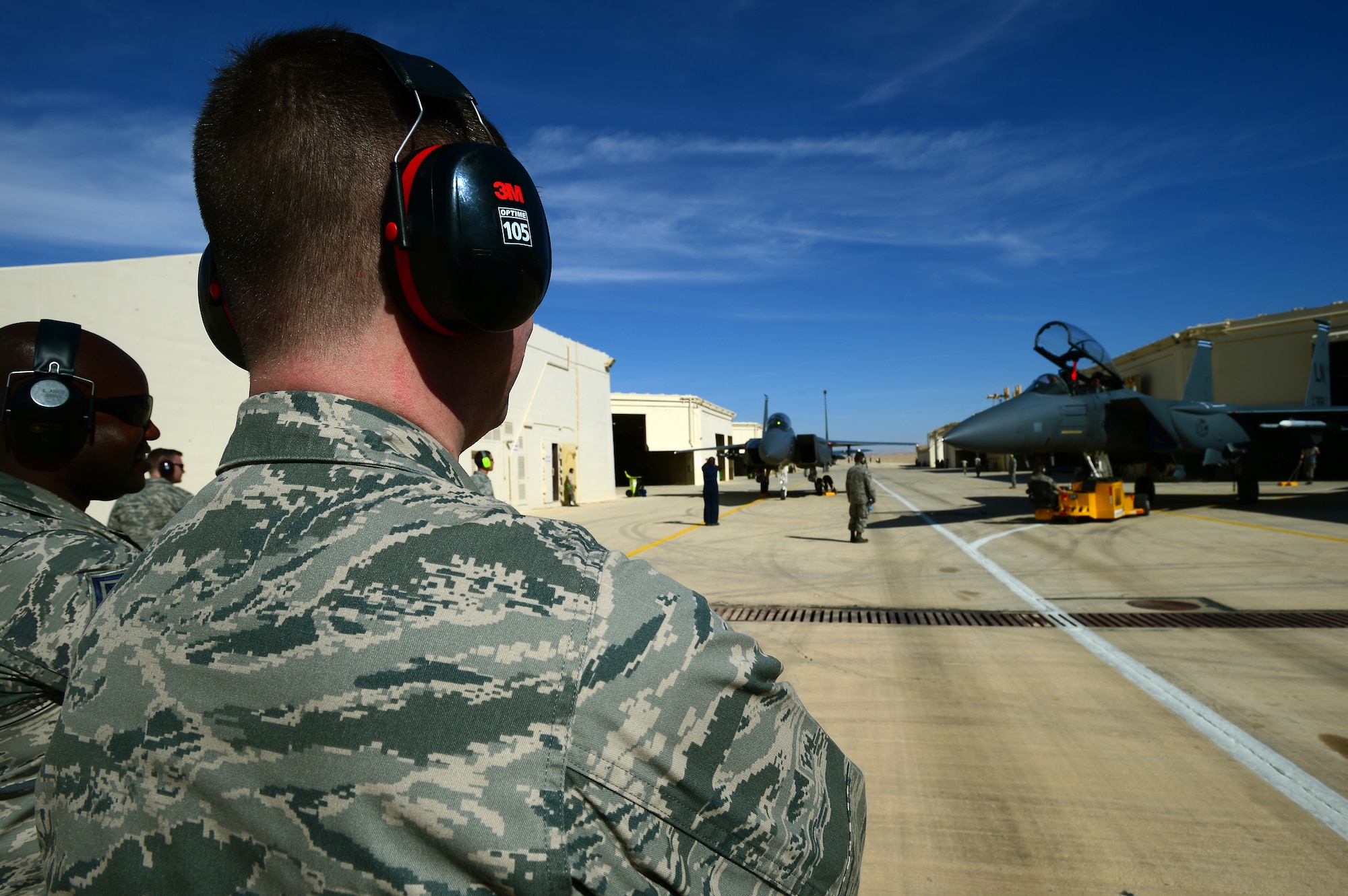 Col. Kyle Robinson (left), 48th Fighter Wing commander, observes 48th Aircraft Maintenance Squadron Airmen, reposition an F-15E Strike Eagle during a visit to Uvda Air Force Base, Israel, for Blue Flag exercise Nov. 25, 2013. Blue Flag was a multinational aerial warfare exercise hosted by Israel Nov. 24- 28 to promote improved operational capability, combat effectiveness, understanding and cooperation between the U.S., Israel, Greece and Italy. (U.S. Air Force photo by Master Sgt. Lee Osberry/Released)