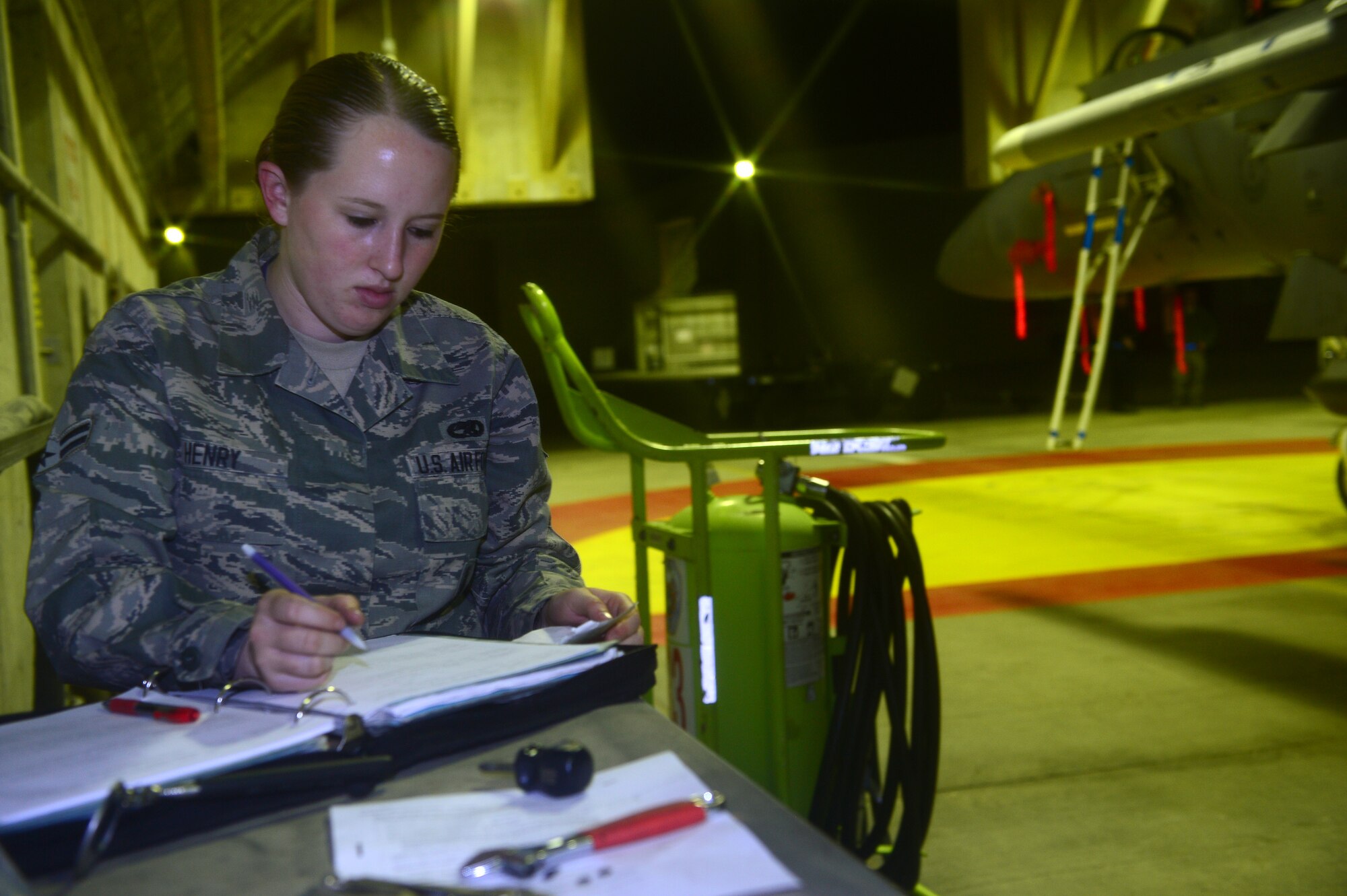 Airman 1st Class Katelyn Henry, 48th Aircraft Maintenance Squadron aircraft armament systems apprentice, prepares forms for future missions during Blue Flag exercise at Uvda Air Force Base, Israel, Nov. 24, 2013. Blue Flag was a combined aerial warfare exercise to improve operational capability, combat effectiveness, understanding and cooperation between the U.S., Israel, Greece and Italy Nov. 24-28.  (U.S. Air Force photo by Master Sgt. Lee Osberry/Released)