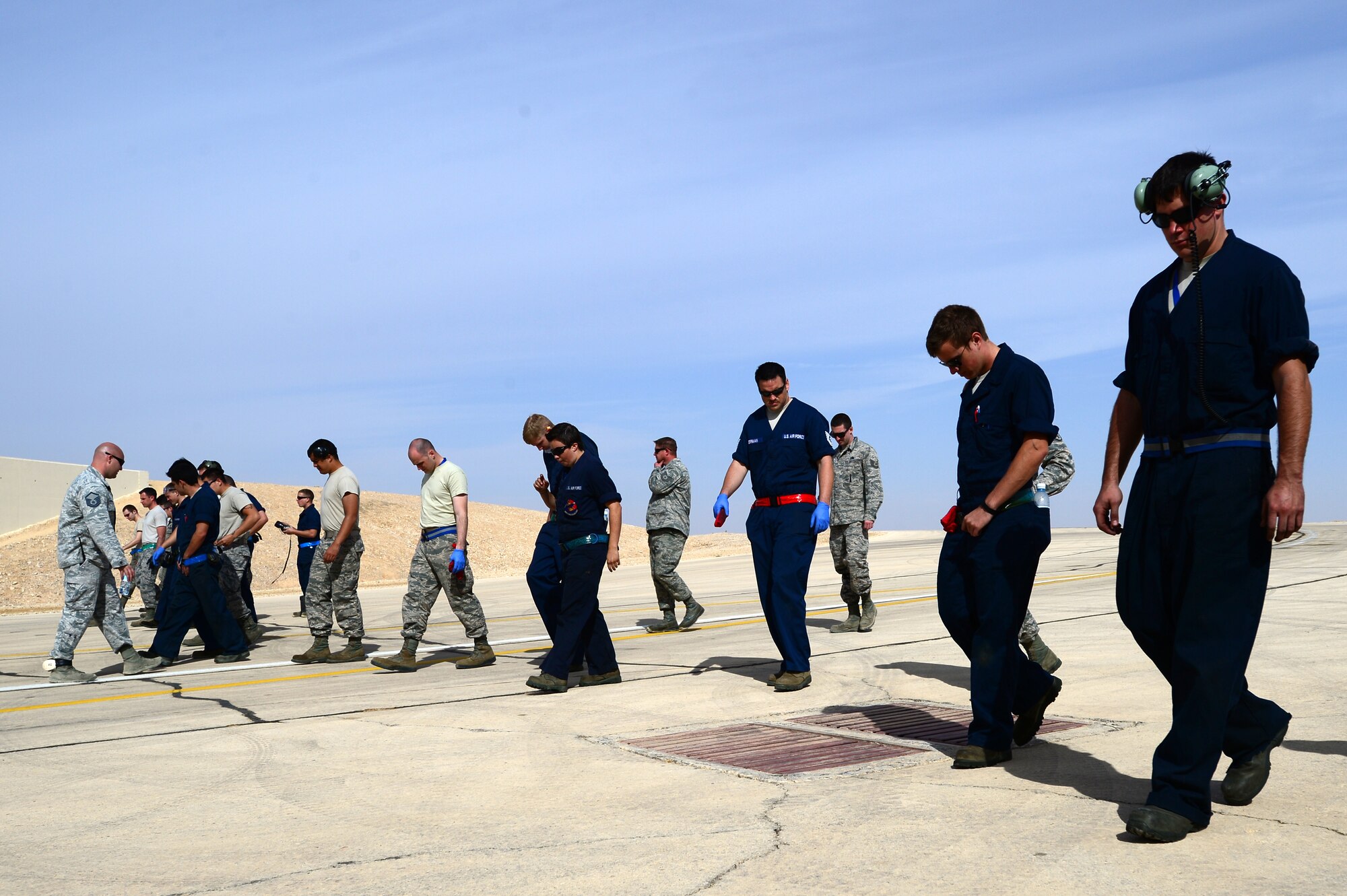 Airmen assigned to  the 48th Aircraft Maintenance Squadron search for foreign object debris walk during Blue Flag exercise at Uvda Air Force Base, Israel, Nov. 24, 2013. The exercise was conducted Nov. 24-28 to help strengthen the relationships between the partner nations, while ensuring regional peace and stability. (U.S. Air Force photo by Master Sgt. Lee Osberry/Released)