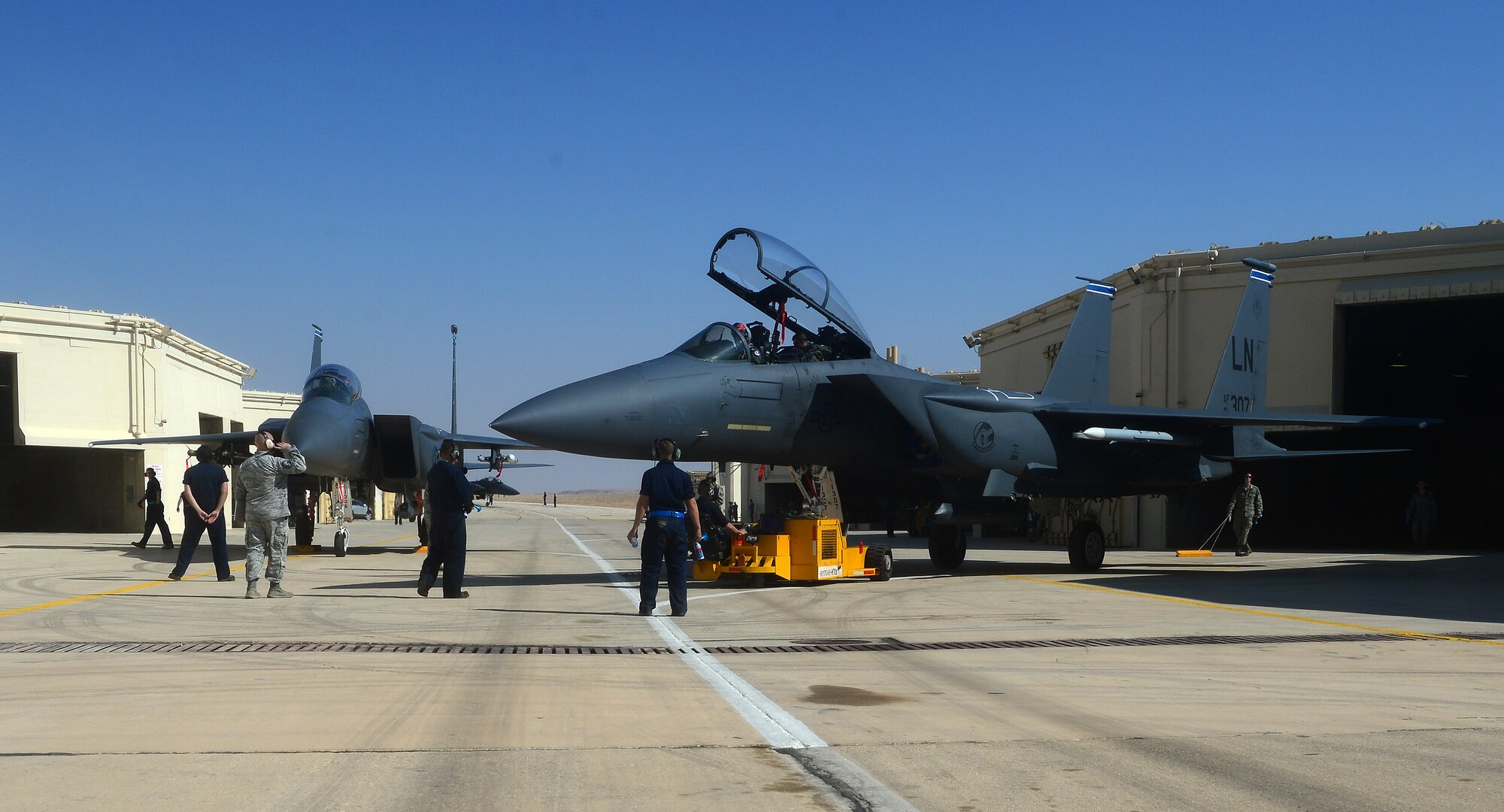 Airmen assigned to the 48th Aircraft Maintenance Squadron, from Royal Air Force Lakenheath, England, reposition an F-15E Strike Eagle prior to the Blue Flag exercise at Uvda Air Force Base, Israel, Nov. 19, 2013. Blue Flag was a combined aerial warfare exercise to improve operational capability, combat effectiveness, understanding and cooperation between the U.S., Israel, Greece and Italy Nov. 24-28. (U.S. Air Force photo by Master Sgt. Lee Osberry/Released)