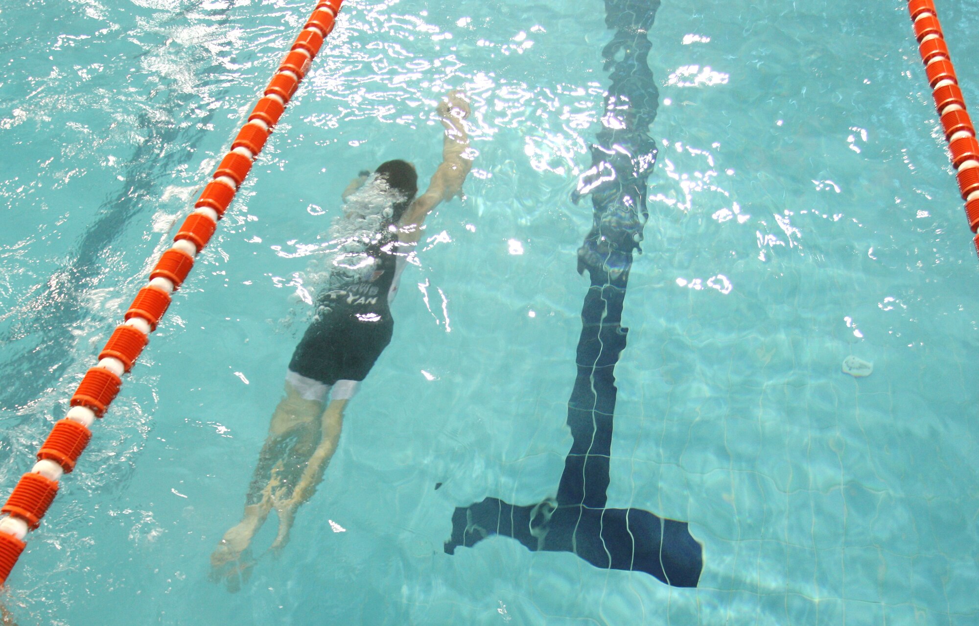 Tech. Sgt.  Ryan Oliver swims 500 meters in a local triathlon in Southwest Asia, Nov. 29, 2013. Oliver placed first in his division and second overall with a time of 1:04:33. Oliver is a 379th Expeditionary Civil Engineering Squadron Explosive Ordnance Disposal technician deployed from Peterson Air Force Base, Colo., and a Panama City, Fla. native (Courtesy photo)