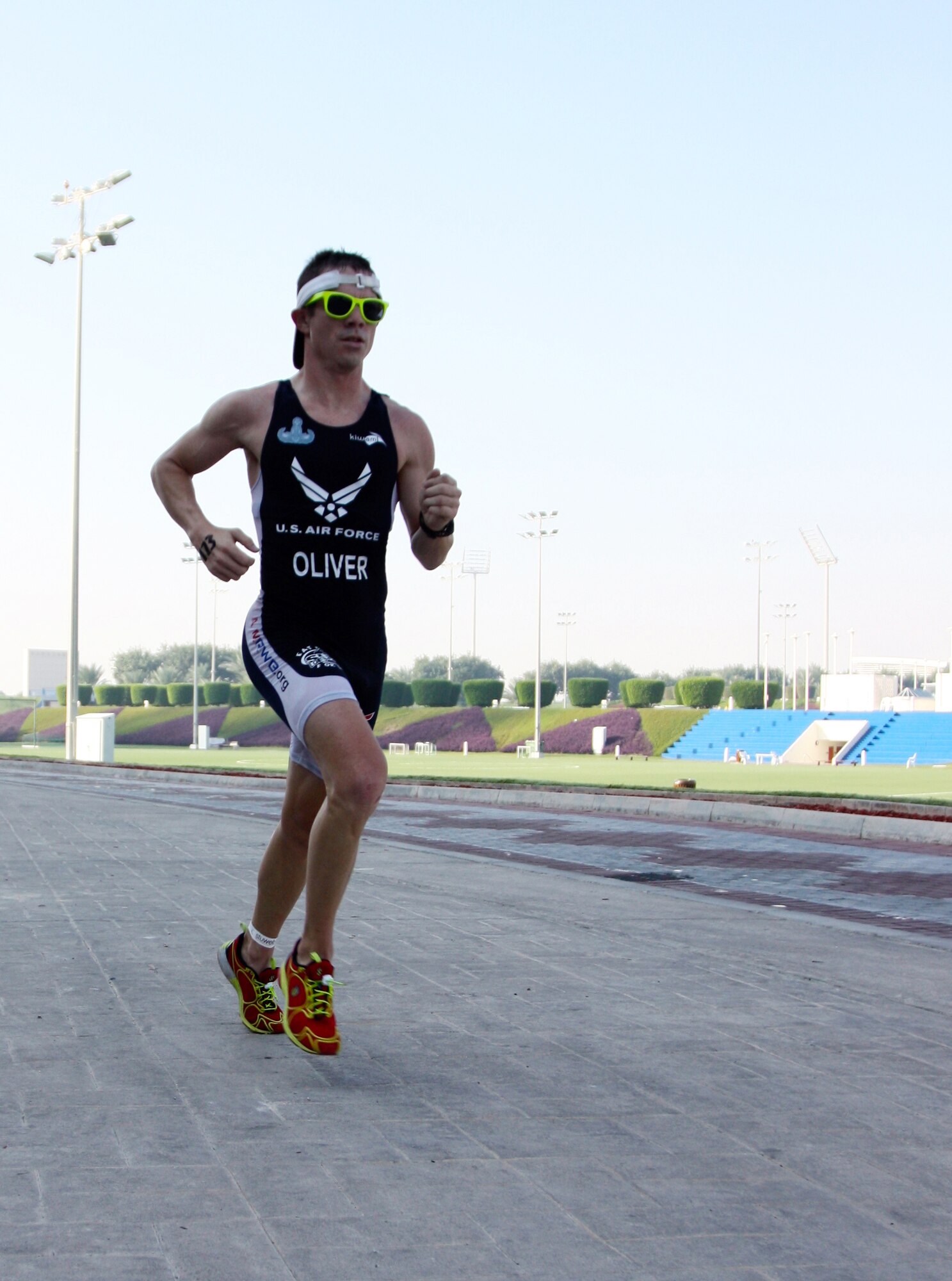 Tech. Sgt.  Ryan Oliver races to the finish during a local triathlon in Southwest Asia, Nov. 29, 2013. Oliver placed first in his division and second overall with a time of 1:04:33. Oliver is a 379th Expeditionary Civil Engineering Squadron Explosive Ordnance Disposal technician deployed from Peterson Air Force Base, Colo., and a Panama City, Fla. native. (Courtesy photo)