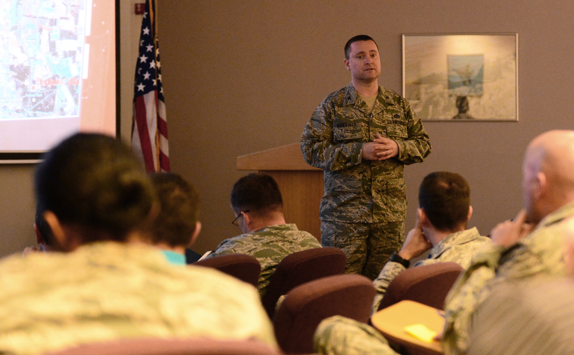 Col. Marc Vandeveer, 48th Mission Support Group commander, answers questions at the town hall meeting at the Royal Air Force Lakenheath, England, Strike Eagle Complex, Dec. 2, 2013. Base housing residents at RAFs Feltwell, Mildenhall and Lakenheath, or military housing in nearby Ely, gathered to discuss various topics.