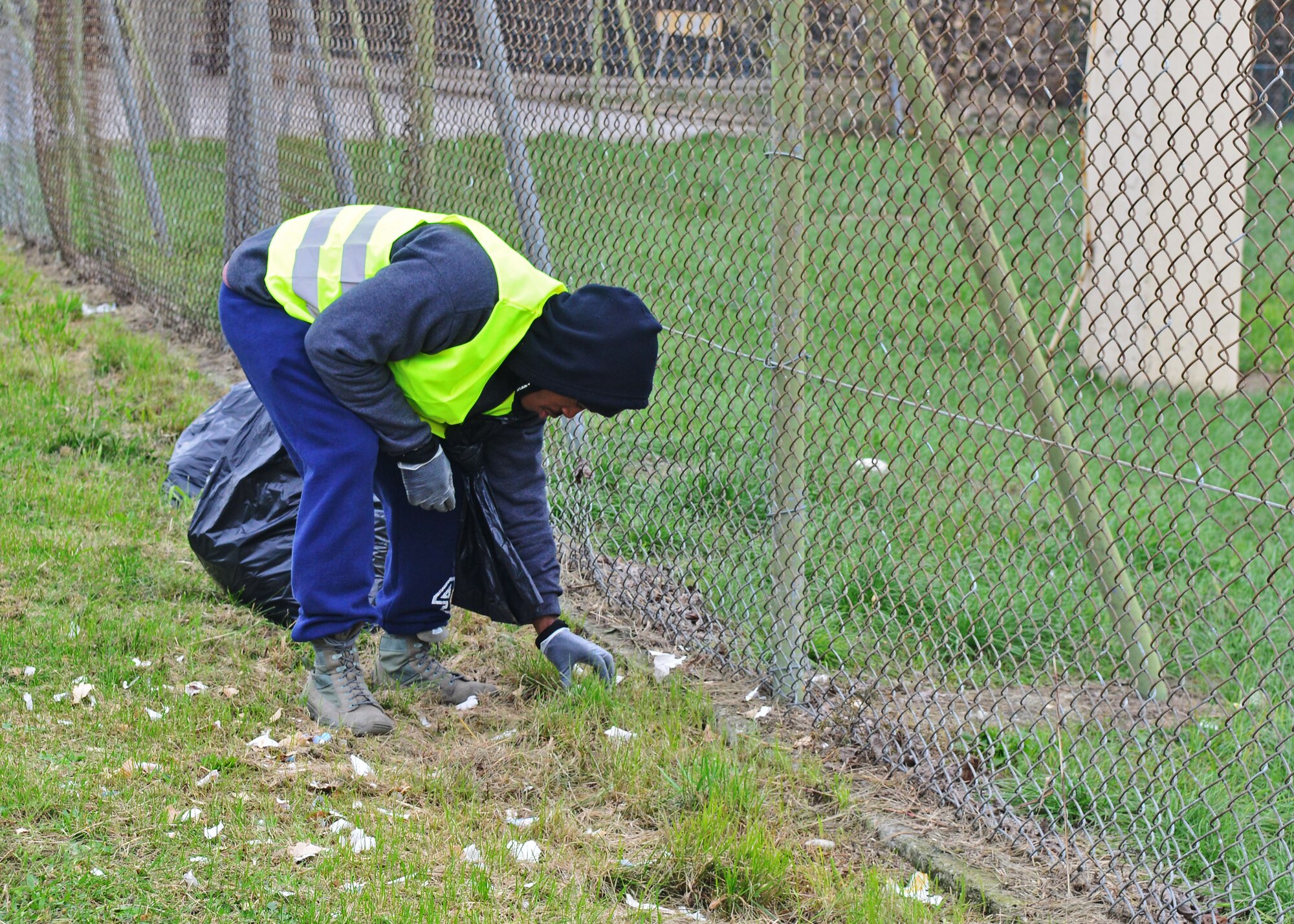 Senior Airman Joshua Treasure, “Troops on Trash” participant, picks up trash along the outside perimeter of the base, Nov. 30, 2013 at Aviano Air Base, Italy. Team Aviano adopted the “Troops on Trash” initiative to ensure the outside perimeter of the base was clear of litter and a way to build camaraderie among volunteers. (U.S. Air Force photo/Senior Airman Briana Jones)