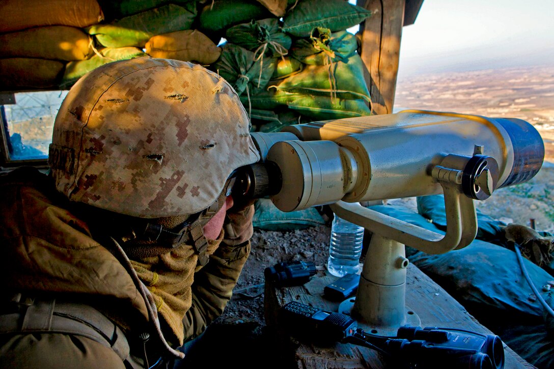 A U.S. Marine scans a mountaintop from Observation Post Athens in Afghanistan's Helmand province, Nov. 28, 2013. The Marine is assigned to 3rd Battalion, 7th Marine Regiment, which provided security for personnel on Forward Operating Base Zeebrugge.