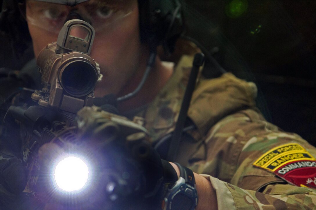 A U.S. Army special forces soldier demonstrates room clearing techniques to Afghan commandos on Camp Commando in Kabul province, Afghanistan, Nov. 27, 2013.
