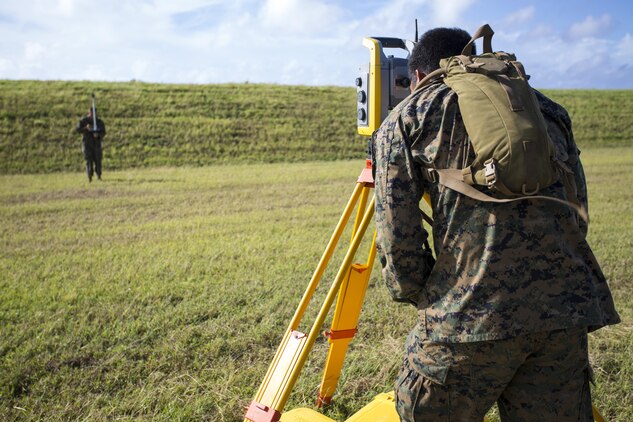 Lance Cpls. Ryan Gamino and Johnny Gomez, right, calculate needed points for M-31 Marine Corps Expeditionary Arresting Gear System as they began setup surveyor lining spots along Tinian’s West Field runway Nov. 22 during exercise Forager Fury II. The joint exercise is designed to employ and assess combat power generation in a deployed and austere environment. Gomez and Gamino are combat engineer drafting and surveyors with Marine Wing Support Squadron 171, Marine Aircraft Group 12, 1st Marine Aircraft Wing, III Marine Expeditionary Force.
