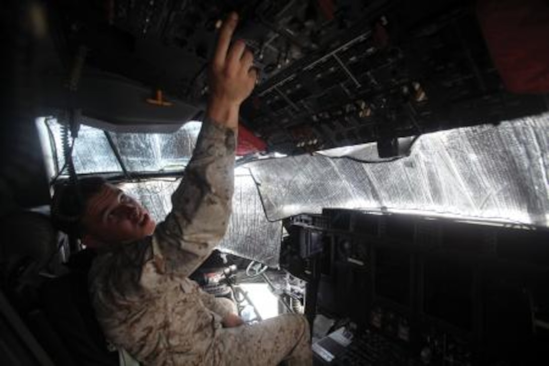 Pfc. Anthony D. Black turns on an auxiliary power unit to start an engine on a KC-130J Super Hercules aircraft May 8 at Marine Corps Air Station Futenma. Black is crewmaster a with Marine Aerial Refueler Transport Squadron 152, Marine Aircraft Group 36, 1st Marine Aircraft Wing, III Marine Expeditionary Force. (Photo by Lance Cpl. Henry J. Antenor)
