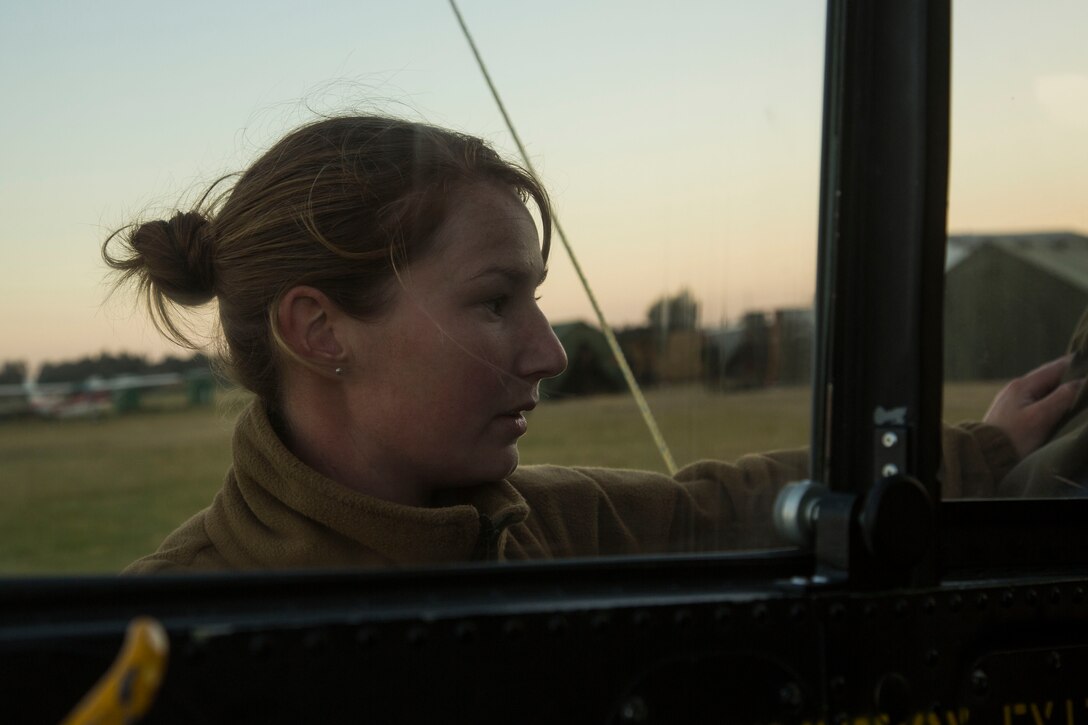 Royal New Zealand Air Force Leading Aircraftsman Emma Jarden, a safety and surface technician with Royal New Zealand Air Force Squadron 3, places safety pins in the cockpit of a UH-1H after an evening flight mission as part of exercise Southern Katipo 2013 (SK13) at Timaru Airfield, Timaru, New Zealand, Nov. 19, 2013. SK13 is a New Zealand led training exercise that strengthens military relations between coalition forces and helps the New Zealand Defence Force further develop its amphibious capabilities. (U.S. Marine Corps photo by Cpl. Luis A. Vega/ Released)