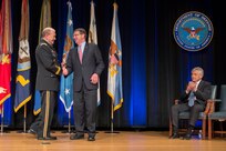 Chairman of the Joint Chiefs of Staff Gen. Martin E. Dempsey shakes hands with outgoing Deputy Defense Secretary Ash Carter during a farewell ceremony for Carter at the Pentagon, Dec. 2, 2013.  Photo by Mass Communication Specialist 1st Class Daniel Hinton.