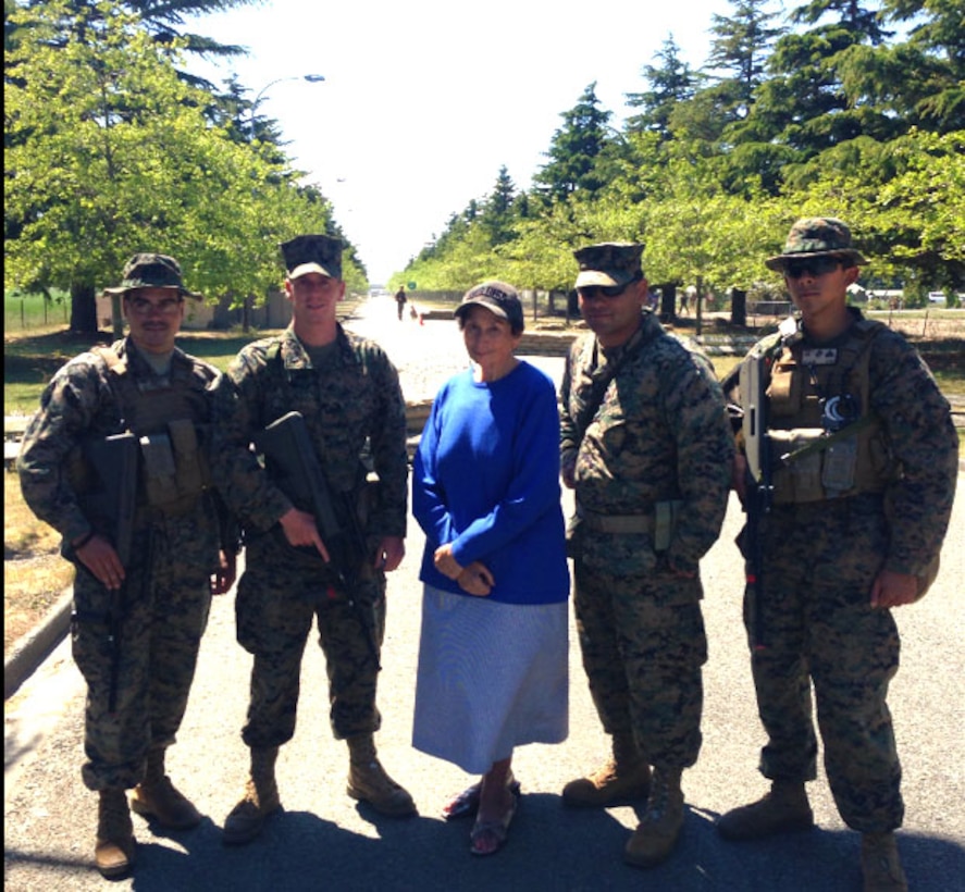 Jane Yarrall poses for a picture with Military Police Marines participating in exercise Southern Katipo 2013 aboard Timaru, New Zealand, Nov. 19, and spoke with them about her experiences with Marines passing through her parents’ Casino Hotel in route to the Pacific during World War II. SK13 strengthens military to military relationships and cooperation with partner nations and the New Zealand Defence Force.