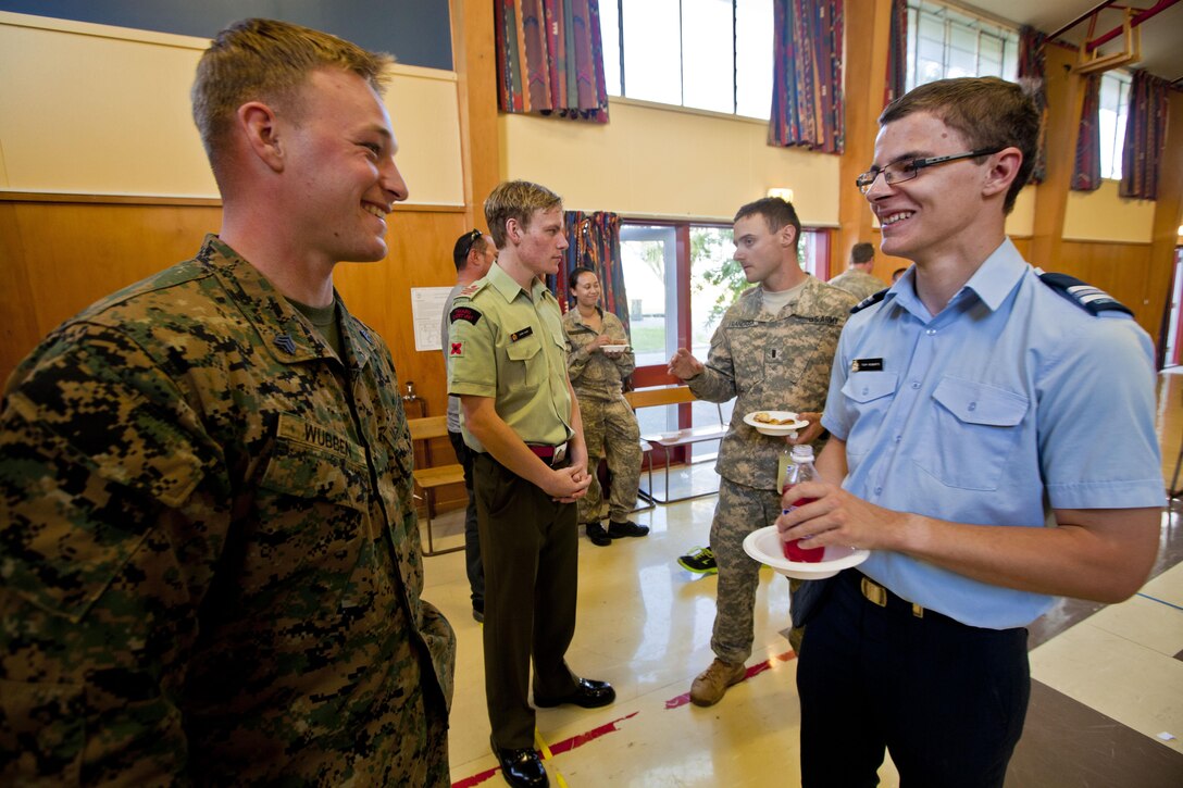 Sgt. Greg Wubben, civil affairs non-commissioned officer with 1st Civil Affairs Group, from Ridgefield, Wash., talks with an Air Force cadet while coalition forces visited the Timaru Christian School during exercise Southern Katipo 2013 aboard Timaru, New Zealand, Nov. 20. SK13 allows our service members to collaborate with partner countries to achieve mutual security goals, address shared concerns and continue to enhance our interoperability.