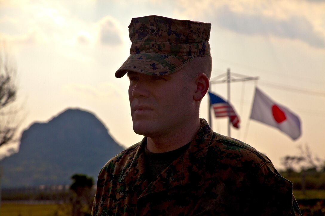 Staff Sgt. Gordon L. Llewellyn stands before a formation while his Navy and Marine Corps Achievement Medal citation is read Dec. 5 at the Ie Shima Training Facility. Llewellyn received the award due to his courageous actions and quick thinking during the rescue of a teenaged girl after she was involved in a car accident Aug. 26. Llewellyn is the staff noncommissioned officer in charge of Ie Shima Training Facility and currently assigned to G-3, operations, Range Control, Marine Corps Base Camp Smedley D. Butler. 