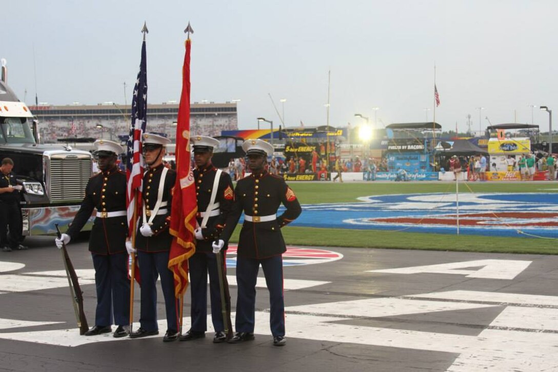 The Recruiting Station Atlanta color guard presents the colors at the AdvoCare 500 at Atlanta Motor Speedway in Hampton, GA, Sept. 1. The AdvoCare 500 is a NASCAR Sprint Cup Series stock car race held at AMS during Labor Day weekend. Recruiting Station Atlanta is a part of 6th Marine Corps District, Eastern Recruiting Region, Marine Corps Recruiting Command. (U.S. Marine Corps photo by Cpl. Courtney G. White/Released)