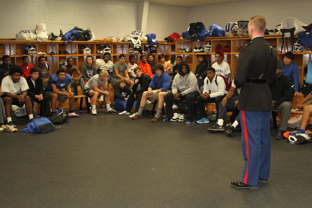 Maj. Seth W. MacCutcheon, commanding officer of Marine Corps Recruiting Station Atlanta, speaks to the Peachtree Ridge High School football team during a jersey presentation at Peachtree Ridge High School in Suwanee, GA, Nov. 20. The presentation spotlighted senior Orlando Brown Jr. as one of 90 high school student athletes selected to play in the Semper Fidelis All-American Bowl on Jan. 5, 2014 in Carson, Calif. The Semper Fidelis All-American Bowl demonstrates the Marine Corps' commitment to developing quality citizens and reinforces core values of honor, courage, and commitment. The Semper Fidelis All-American Bowl offers an opportunity for quality players, coaches and Marines to meet, practice and work together to teach skills important on and off the field, such as leadership, self-confidence and teamwork. The game airs on Jan. 5, 2014 at 9 p.m. Eastern Standard Time live on Fox Sports 1. (U.S. Marine Corps photo by Cpl. Courtney G. White/Released)