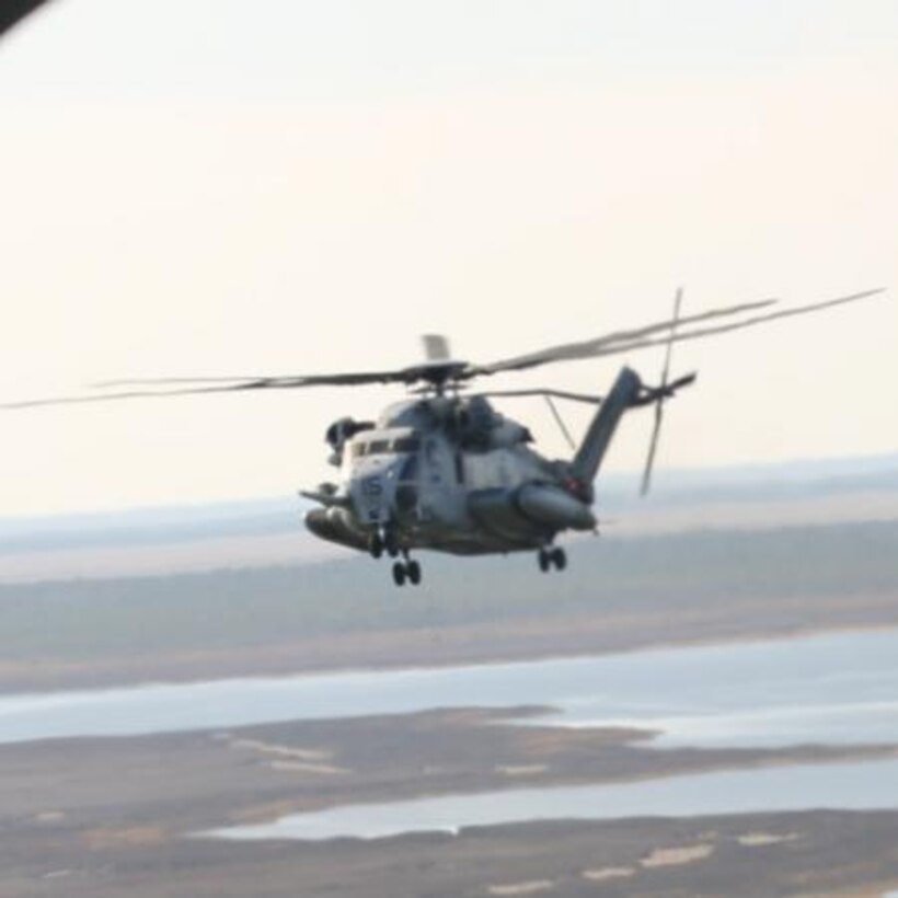 A CH-53E Super Stallion flies over bombing target 11 northwest of Marine Corps Outlying Field Atlantic Dec. 3. Marines with Marine Heavy Helicopter Squadron 366 conducted tactical aerial insertion drills.